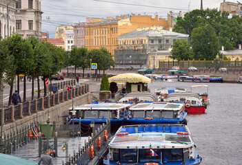 pleasure boats on the background of the Lomonosov bridge on Fontanka