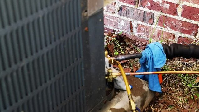 Technician brazing copper on an HVAC system