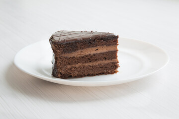 Chocolate cakeclose-up is on a white plate. - 482978376