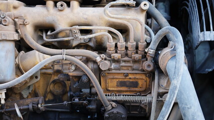 Dirty diesel car injector pump. Closeup of old injector on a small 4-injector diesel engine that is leaking and dirty with dust. Selective focus