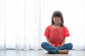 Asian girl meditating, lovely kid