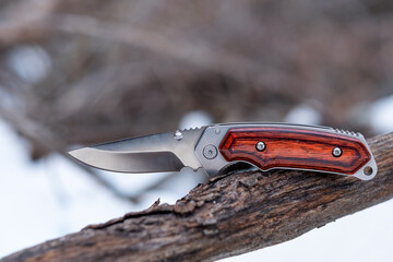 A folding pocket knife outdoors in the snow