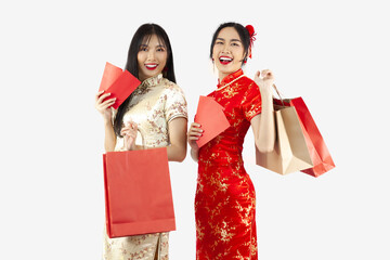 Chinese new year in shopping concept style. Two Asian woman in cheongsam dress holding shopping...