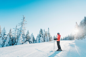 Skiing. Ski portrait of woman alpine skier holdings skis wearing helmet, cool ski goggles and...