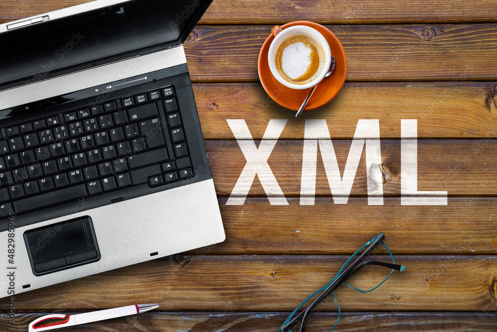 Wall mural extensible markup language. word xml on wooden desk with laptop