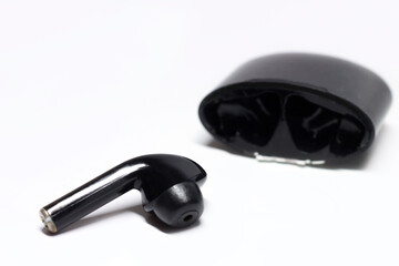 Black Wireless headphones, music gadget on a light background