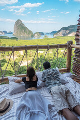 Happy Couple traveler enjoy Phang Nga bay view point, Tourists relaxing in tropical resort at Samet Nang She, near Phuket in Southern Thailand. Southeast Asia travel and summer vacation concept