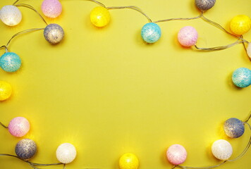 LED cotton ball garland decorate on yellow background