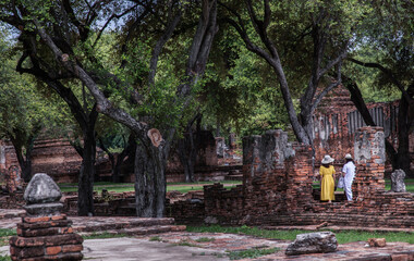 Fototapeta na wymiar Aytthaya, Thailand, 22 Aug 2020 : Two tourist woman walking at Wat Ratchaburana. Ayutthaya province, No focus, specifically.