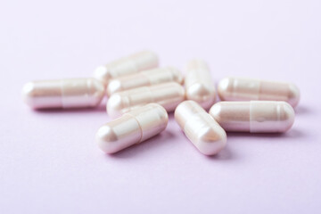 Carnitine capsules. Concept for a healthy dietary supplementation. Bright paper background. Soft focus. Close up.