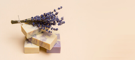 Natural handmade soap with dried lavender and essential oil on pink background. Zero waste concept