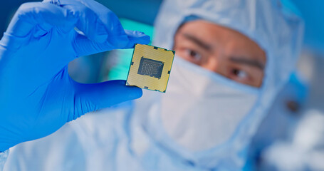 engineer holds microchip