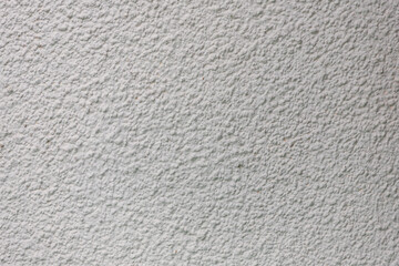 Background from a pattern of gray stone wall covered with decorative plaster.