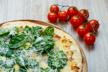 pizza with spinach and mozzarella extra shredded chessee