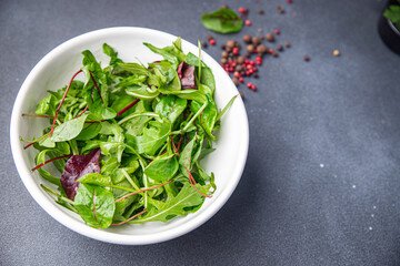 salad leaves mix arugula, spinach, lettuce, frise, radicchio, mung bean salad fresh dietary healthy meal diet still life snack on the table copy space food background vegan or vegetarian food
