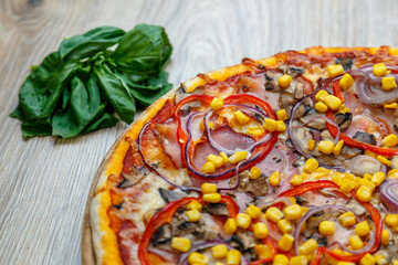 pizza with prosciutto, onion, red pepper, corn, tomato sauce, mushroom and cheese