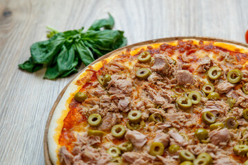 pizza with tuna, green olives and tomato sauce