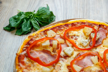 pizza with ham, mozzarella, red pepper and pineapple