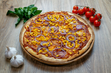 pizza with ham, corn, onion rings and mozzarella