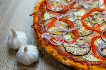 pizza vegetarian with eggplant, zucchini, onion rings and tomato sauce