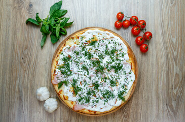 Fototapeta na wymiar pizza with ham, sour cream, mozarella and dill