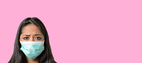 Woman wearing a green medical protective mask against Covid