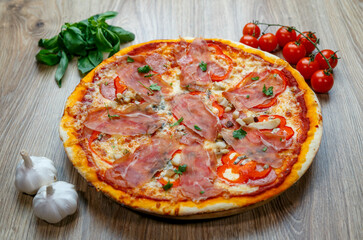 pizza with prosciutto crudo, mushrooms, mozarella, red bell peppers and parsley