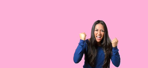 Enthusiastic young woman throwing a temper tantrum balling her fists