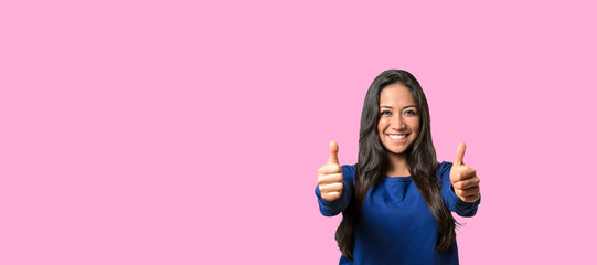 Elated successful young woman giving a double thumbs up