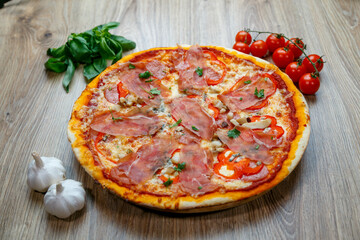 pizza with prosciutto crudo, mushrooms, mozarella, red bell peppers and parsley