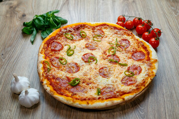 pizza with salami, mozarella, green hot pepper