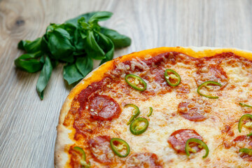 pizza with salami, mozarella, green hot pepper