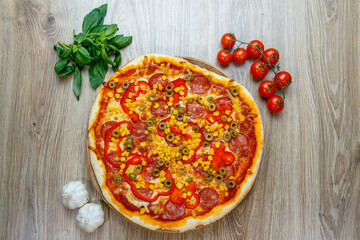 pizza with mozzarella, green olive, salami, corn and red pepper