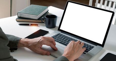 Man using laptop computer at home, mockup blank screen for product display.