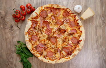 pizza with chicken breast, mozzarella, salami and tomato sauce