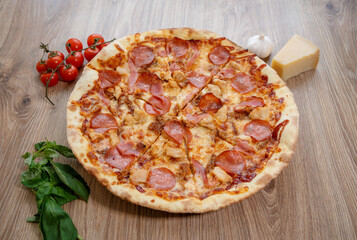 pizza with chicken breast, mozzarella, salami and tomato sauce