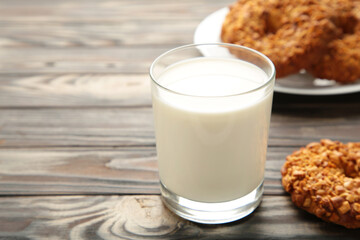 Peanut cookies on cutting board with milk on brown wooden background. Vertical photo.