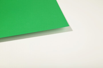 Green and white paper texture background with shadow, copy space.