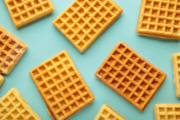Waffles on blue background with copy space.