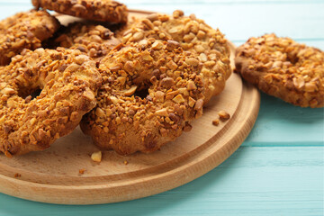 Peanut cookies on cutting board on blue wooden background. Bakery products.