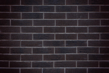 Dark brown brick wall, decorative brick tiles. Background texture of brick wall. Copy space