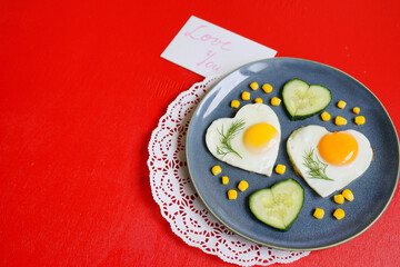 fried eggs in shape of heart. St Valentin's Day celebration. Romantic breakfast. Love atmosphere. Creative dish. 