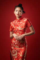 Asian chinese woman in traditional dress on red background. Chinese new year festival,