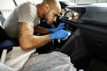 A man cleaning car interior, car detailing in Carwash service