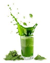 Splash with drops of green organic spinach smoothie or juice in drinking glass with falling or levitating leaves ingredient full of vitamins isolated on white background. Healthy dieting concept