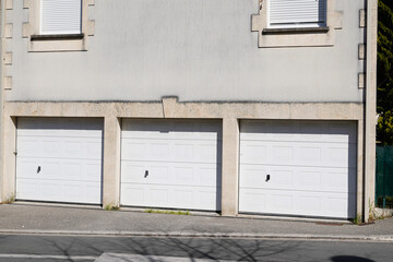 Fototapeta na wymiar residential triple garage door car garages building in suburban area