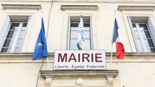 Mairie liberte egalite fraternite french text means city hall liberty equality fraternity facade in town center with french europe flag on stone building