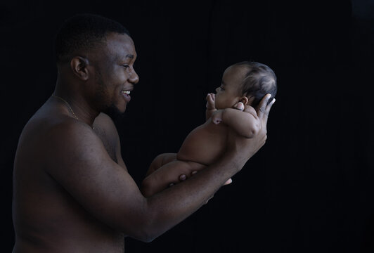 Black father holding a baby of newborn.African American Ethnicity people.