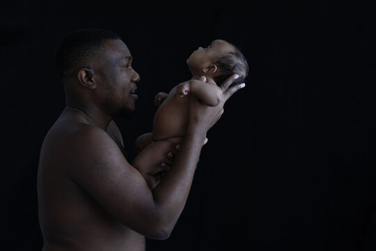 Black father holding a baby of newborn.African American Ethnicity people.