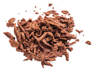 Grated Chocolate pieces isolated on white background. Crushed dark chocolate Top view. Flat lay.